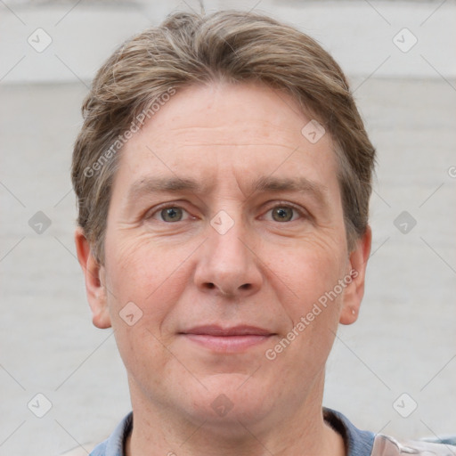 Joyful white adult male with short  brown hair and grey eyes