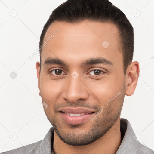 Joyful white young-adult male with short  brown hair and brown eyes