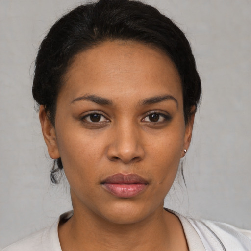 Joyful latino young-adult female with short  black hair and brown eyes