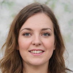 Joyful white young-adult female with long  brown hair and green eyes