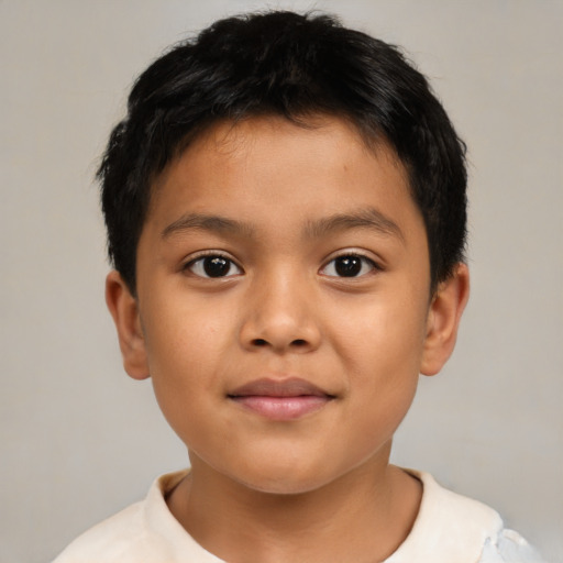 Joyful latino child male with short  brown hair and brown eyes