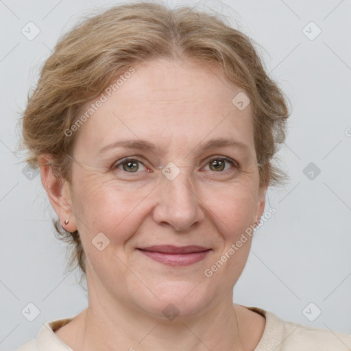 Joyful white adult female with medium  brown hair and blue eyes