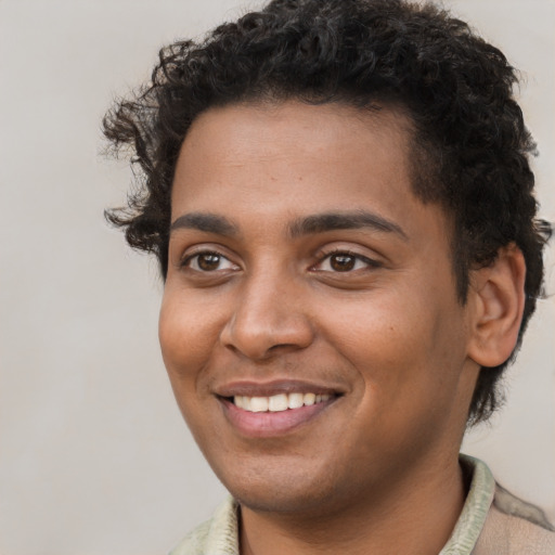 Joyful black young-adult male with short  brown hair and brown eyes