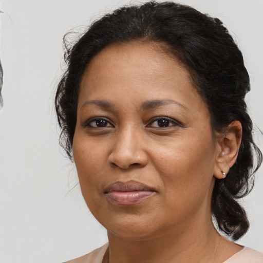 Joyful latino adult female with medium  brown hair and brown eyes