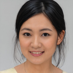 Joyful asian young-adult female with medium  black hair and brown eyes