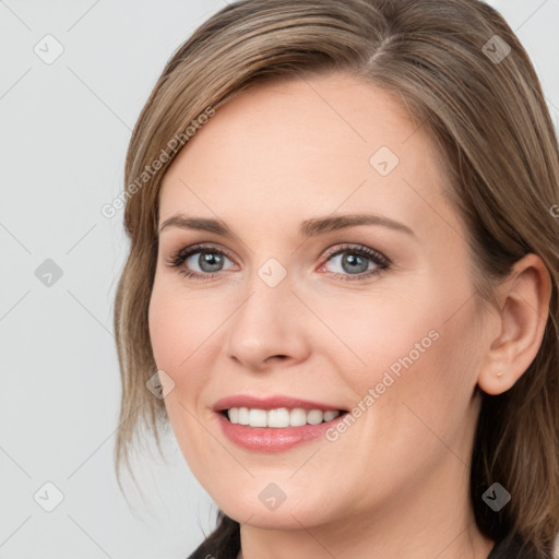 Joyful white young-adult female with medium  brown hair and grey eyes