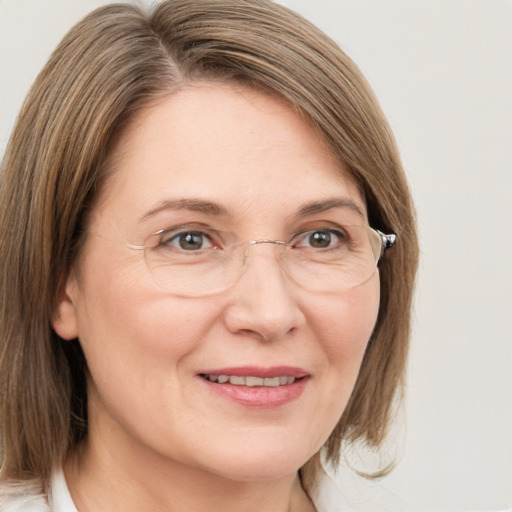 Joyful white adult female with medium  brown hair and grey eyes