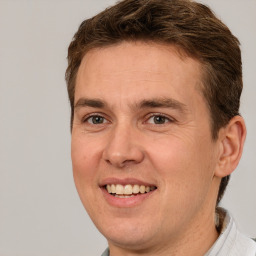 Joyful white adult male with short  brown hair and brown eyes