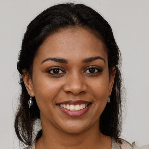 Joyful black young-adult female with medium  brown hair and brown eyes