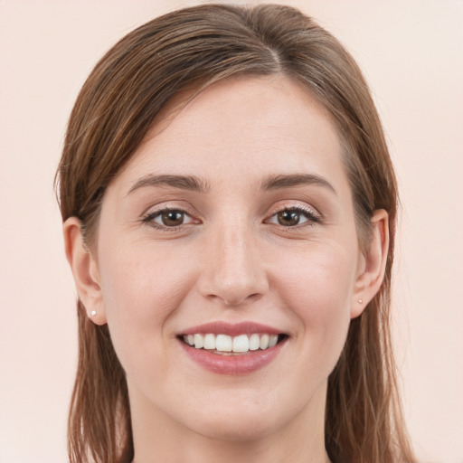 Joyful white young-adult female with long  brown hair and grey eyes