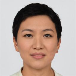 Joyful asian young-adult female with short  black hair and brown eyes