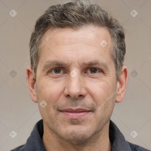 Joyful white adult male with short  brown hair and brown eyes