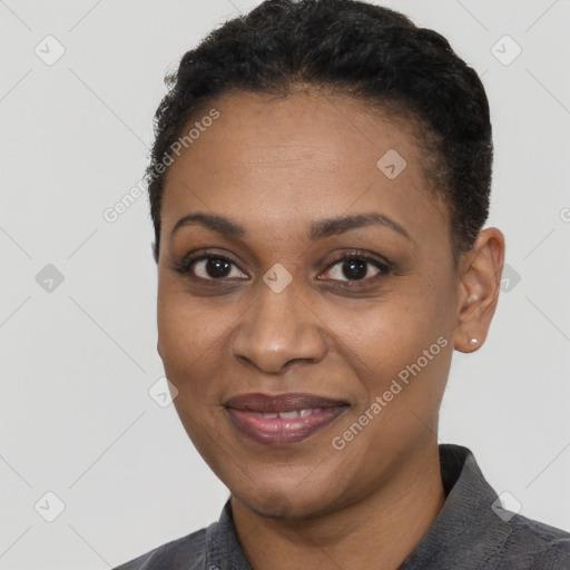 Joyful black adult female with short  black hair and brown eyes