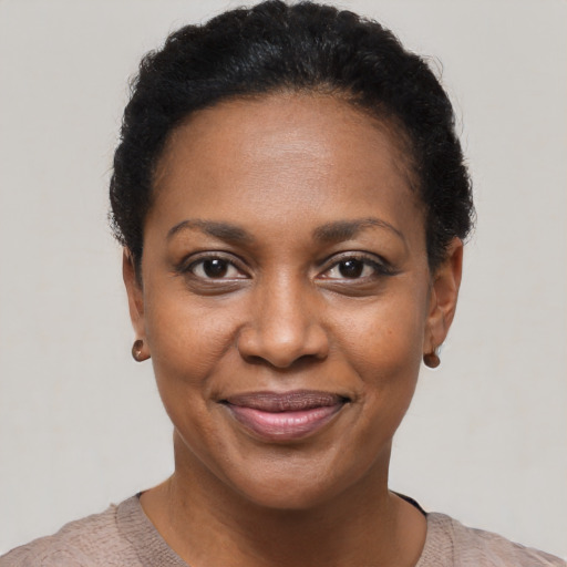 Joyful black young-adult female with short  black hair and brown eyes