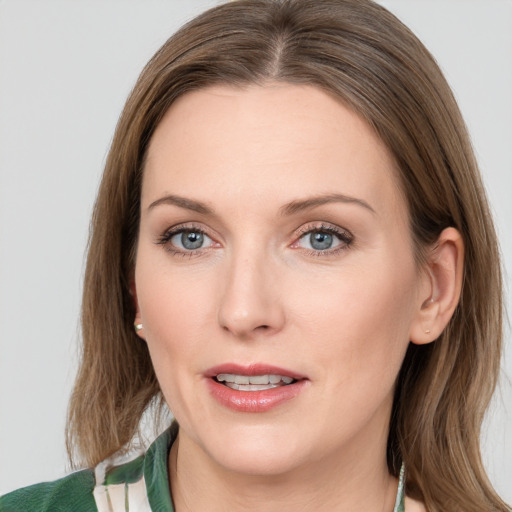 Joyful white young-adult female with medium  brown hair and green eyes