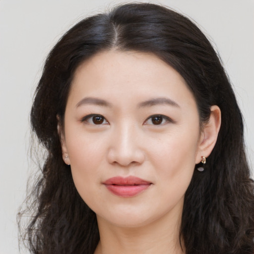 Joyful asian young-adult female with long  black hair and brown eyes