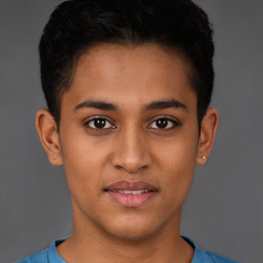 Joyful latino young-adult male with short  brown hair and brown eyes
