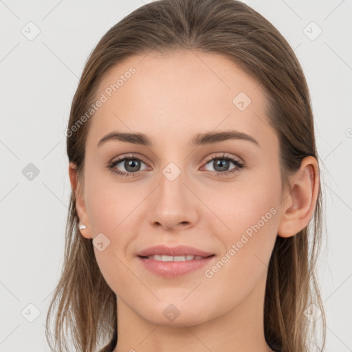 Joyful white young-adult female with long  brown hair and grey eyes