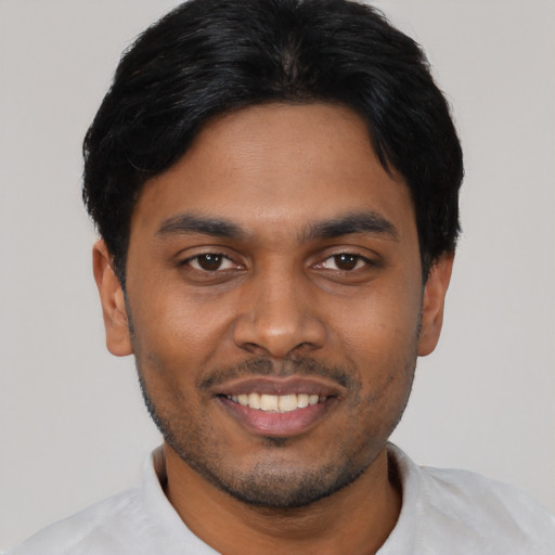 Joyful latino young-adult male with short  black hair and brown eyes