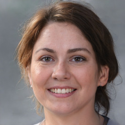 Joyful white adult female with medium  brown hair and brown eyes