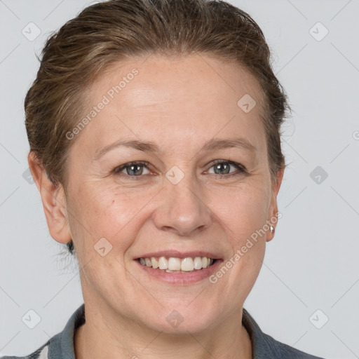 Joyful white adult female with medium  brown hair and grey eyes