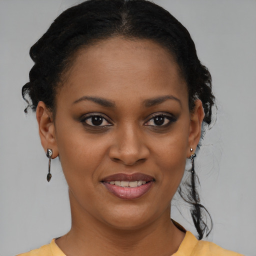 Joyful black young-adult female with short  brown hair and brown eyes