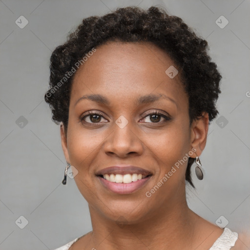 Joyful black young-adult female with short  brown hair and brown eyes