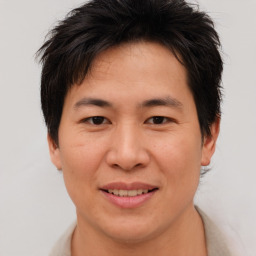 Joyful asian young-adult male with short  brown hair and brown eyes