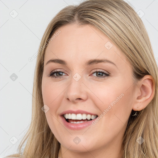 Joyful white young-adult female with long  brown hair and brown eyes