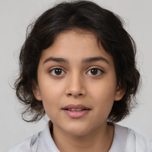 Joyful white child female with medium  brown hair and brown eyes