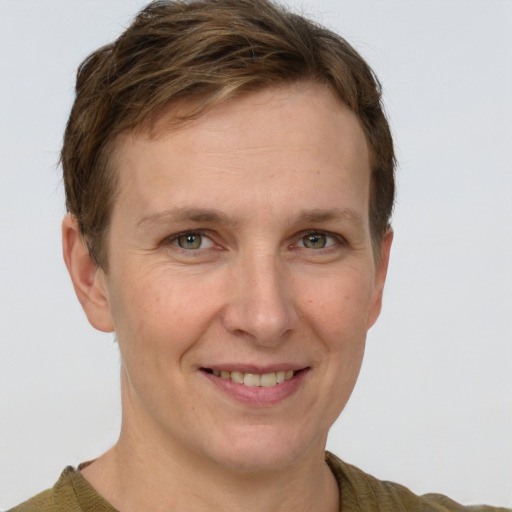 Joyful white adult female with short  brown hair and grey eyes