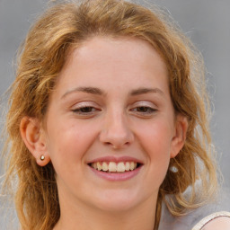 Joyful white young-adult female with medium  brown hair and blue eyes