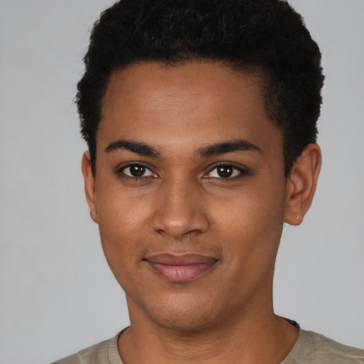 Joyful black young-adult male with short  black hair and brown eyes