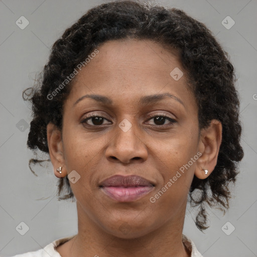 Joyful black adult female with medium  brown hair and brown eyes