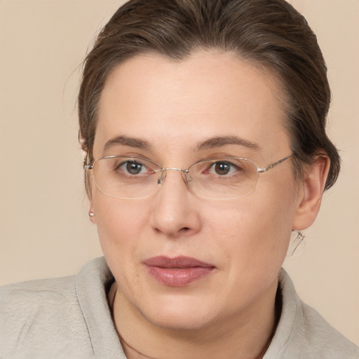 Joyful white adult female with medium  brown hair and brown eyes