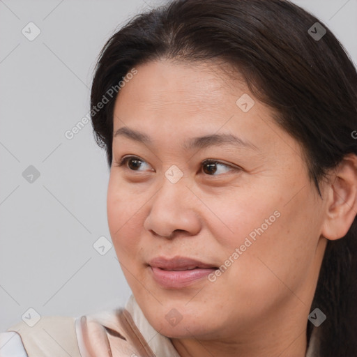 Joyful white adult female with medium  brown hair and brown eyes