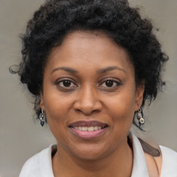 Joyful black adult female with medium  brown hair and brown eyes