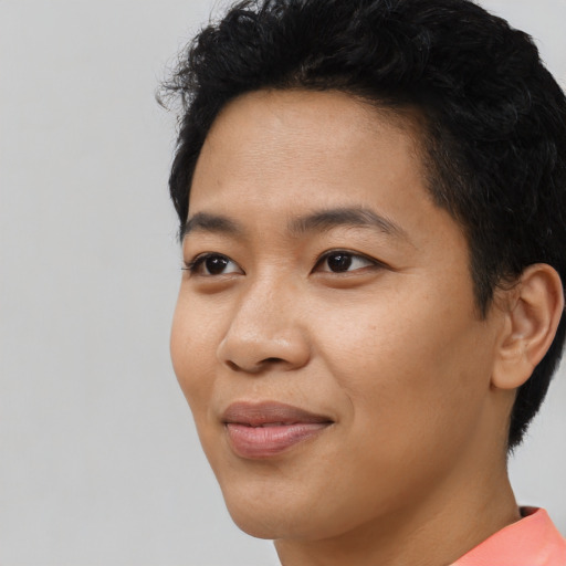 Joyful asian young-adult male with short  black hair and brown eyes