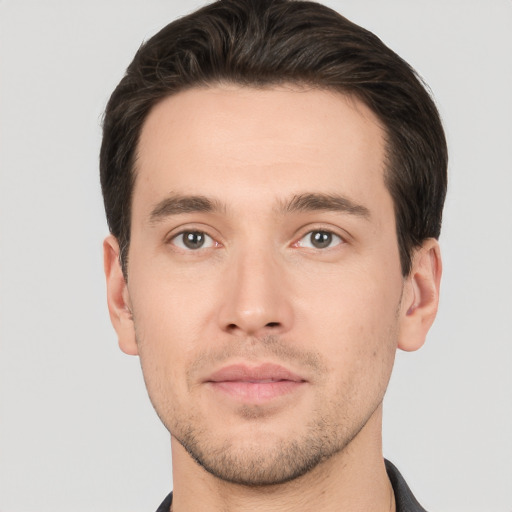 Joyful white young-adult male with short  brown hair and brown eyes