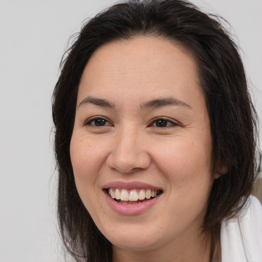 Joyful white young-adult female with medium  brown hair and brown eyes