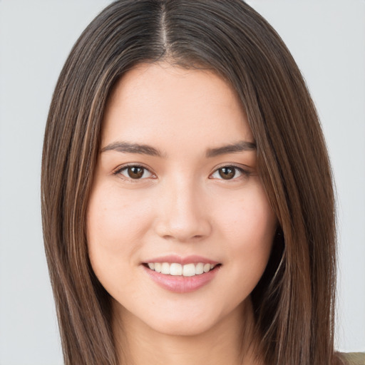 Joyful white young-adult female with long  brown hair and brown eyes