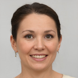 Joyful white adult female with short  brown hair and grey eyes