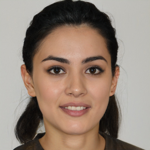 Joyful latino young-adult female with medium  black hair and brown eyes