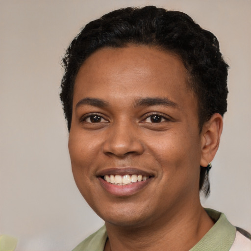Joyful black young-adult male with short  black hair and brown eyes