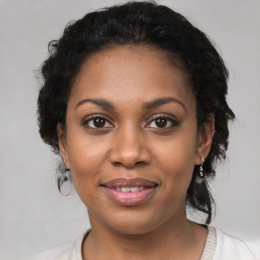 Joyful black young-adult female with medium  brown hair and brown eyes