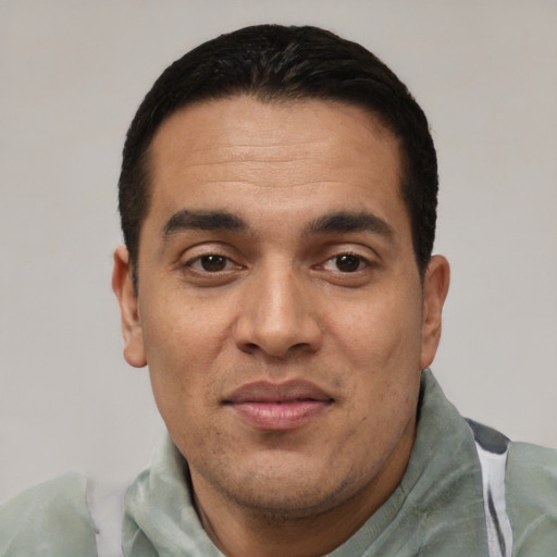 Joyful white adult male with short  black hair and brown eyes
