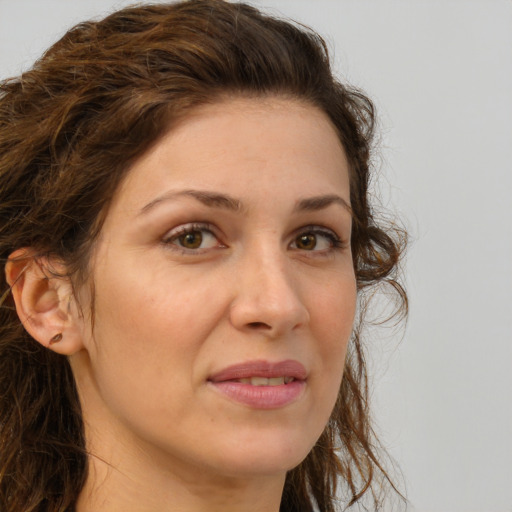 Joyful white adult female with long  brown hair and brown eyes