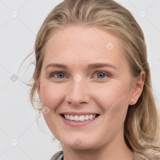 Joyful white young-adult female with medium  brown hair and blue eyes