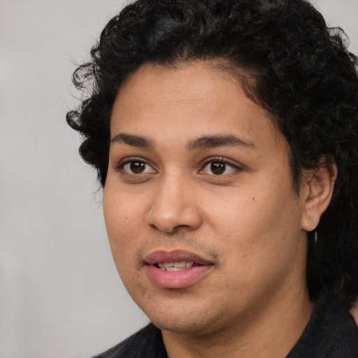Joyful latino young-adult female with short  black hair and brown eyes
