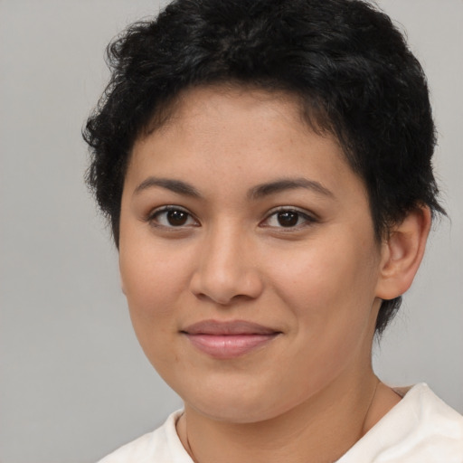 Joyful latino young-adult female with short  brown hair and brown eyes